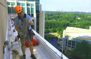 A structural engineer prepares to use rope access.